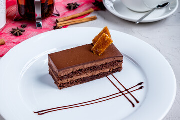Wall Mural - Chocolate cake slice on a white plate