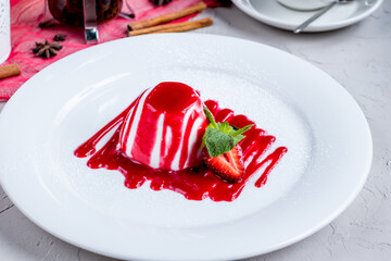 Wall Mural - Panna cotta with strawberry sauce and mint on white plate