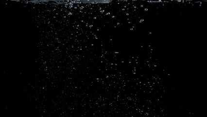  Close-up images of soda water splashing in the water to many little bubbles that make it feel like refreshing and black background 