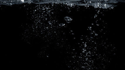 Wall Mural - Close-up images of soda water splashing in the water to many little bubbles that make it feel like refreshing and black background 