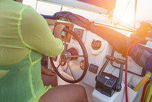 Hand Of Woman On The Steering Wheel Sailboat. Hands On The Sailboat's Steering Wheel. Woman's Hands Steering Wheel Of Yacht. Close-up Of Female Hands On The Yacht Steering Wheel