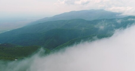 Wall Mural - aerial drone view over the mountain hills with a morning fog and clouds