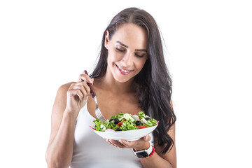 Wall Mural - Beautiful woman holding a fork and eating healthy vegetarian salad