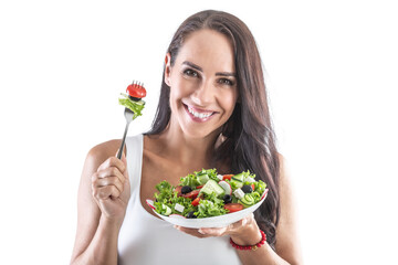 Wall Mural - Smiling brunette holding a fork and eating healthy vegetarian salad