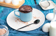 mugcake is microwaved. Homemade cupcake in a mug is on a plate. Chocolate brownie mug cake. Easy cooking concept, microwave baking. muffin chocolate. ingredients, eggs, milk, cocoa. sweet tasty mug