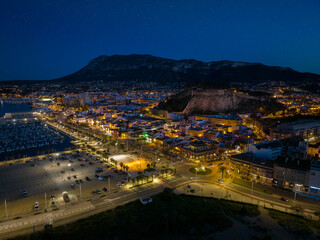 Wall Mural - Denia on the Costa Blanca in the evening after the blue hour. A drone shot from the edge of the harbour.