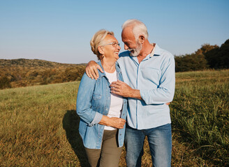 Wall Mural - woman man outdoor senior couple happy lifestyle retirement together smiling love hug nature mature