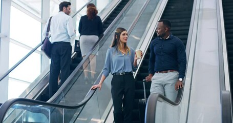 Poster - Back to work after break time. 4k video footage of two young businesspeople coming down the escalator at work.