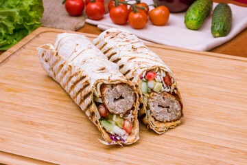 Sticker - roll with beef lula kebab with vegetables on the Board