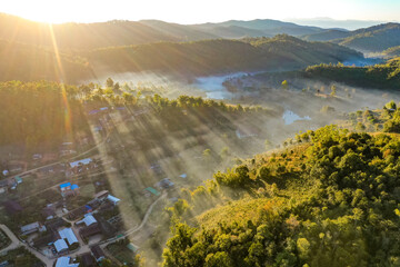 Aerial view of Sunrise with fog over Ban Rak thai, chinese village near a lake in Mae Hong Son, Thailand