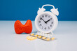 Model of gland and alarm clock with medicines. Health check up and disease prevention concept