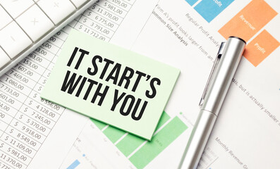 Wall Mural - IT STARTS WITH YOU text written on white background with keyboard, paper sheet and pen