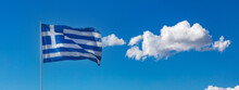 Greece Sign Symbol. Greek National Official Flag On Flagpole Waving In The Wind, Blue Sky