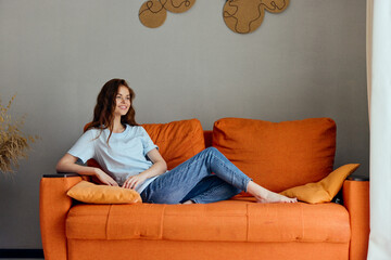 Poster - cheerful woman on the couch rest fun Comfort unaltered