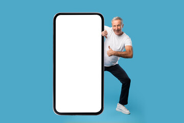 Poster - Man peeping out big white empty smartphone screen, mock-up