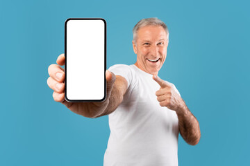 Poster - Excited mature man pointing finger at empty smartphone screen