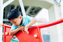 Little Boy Playing On Playground Equipment