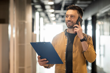 Sticker - Cheerful Business Man Talking On Smartphone Walking In Modern Office