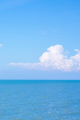 Wall Mural - sea or ocean calm water with blue sky and white clouds.