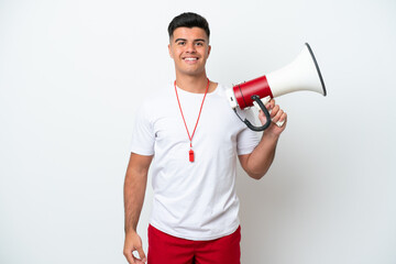 Wall Mural - Young handsome man isolated on white background with lifeguard equipment and shouting through a megaphone