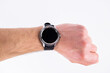 © dyachenkopro - round smart watch on a male hand on a white background