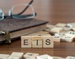 canvas print picture - the acronym eis for enterprise investment scheme word or concept represented by wooden letter tiles on a wooden table with glasses and a book