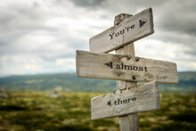 Youre Almost There Text Quote Written In Wooden Signpost Outdoors In Nature. Moody Theme Feeling.