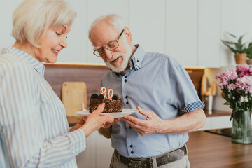 Wall Mural - Senior couple celebrating birthday at home