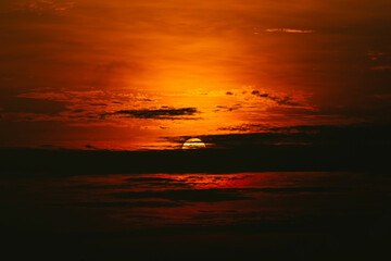 Wall Mural - big sun behind the cloud at sunrise time on the morning.