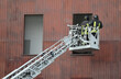 firefighter in action in the fire station with the basket of the ladder truck