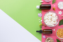 Flat Lay Composition Of Various Vitamin Capsules And Dietary Supplements On Green,pink And White Background With Copy Space. Foodstuffs Concept.