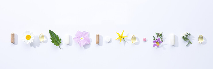 Poster - Vitamin capsules and dietary supplements isolated on with background . Panoramic format.