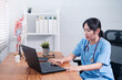© Have a nice day  - Asian Chinese female doctor using computer laptop in office,  professional specialist medical healthcare staff in hospital, wearing white coat stethoscope working during covid19 pandemic.