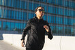 © ADDICTIVE STOCK - Sportive woman running in city on sunny day