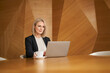 © baranq - Mature businesswoman working on laptop at modern office