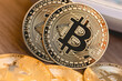© Rmcarvalhobsb - Bitcoin, criptomoeda. Moedas douradas representando o Bitcoin em superfície de madeira em fotografia com vista de perto.