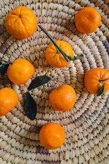 Sticker - oranges with green leaves in the middle of handmade Iraqi woven basket made of date palm leaves