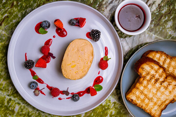 Poster - terrine de foie gras on grey plate with berries top view