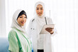 © Art_Photo - Muslim asian woman doctor service help support discussing and consulting talk to muslim woman patient at meeting health medical care express trust concept in hospital.healthcare and medicine