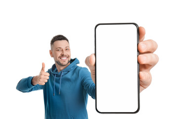 Happy man showing mobile phone with blank screen on white background