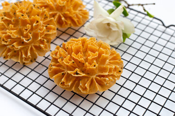 Wall Mural - Crispy lotus blossom cookie in white background.