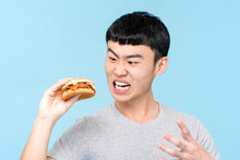 Mad Asian Man With Burger