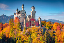Attractive Autumn Scene Of Neuschwanstein Castle, 19th-century Hilltop Fairytale Castle. Impressive Morning Scene Of Bavaria. Spectacular Landscape Of Alps, Germany. Traveling Concept Background.