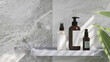3D render mock up, close up of toiletries containers on tray shelve in luxury bathroom with marble wall tiles in background. Tropical plants leaves and morning sunlight. Copy space, Blank label.