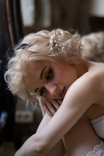 Thoughtful Young Woman With Blond Hair
