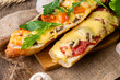 Appetizing homemade pizza cooked on a baguette, homemade pastries, pizza sandwich close-up.