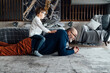 © Westend61 - Boy sitting on back of grandfather lying on carpet at home