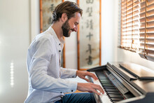 Man Playing Piano At Home