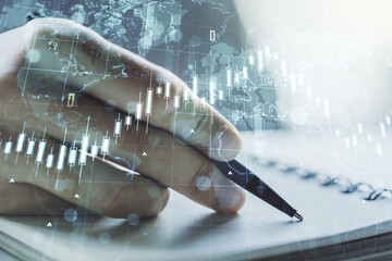 Poster - Multi exposure of abstract creative financial chart with world map and with man hand writing in notebook on background, research and analytics concept