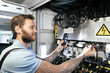 © Westend61 - Engineer examining cables in server room at industry